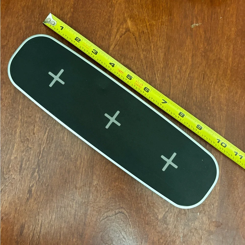 Wireless charger pad with 2 USB ports and power cord.